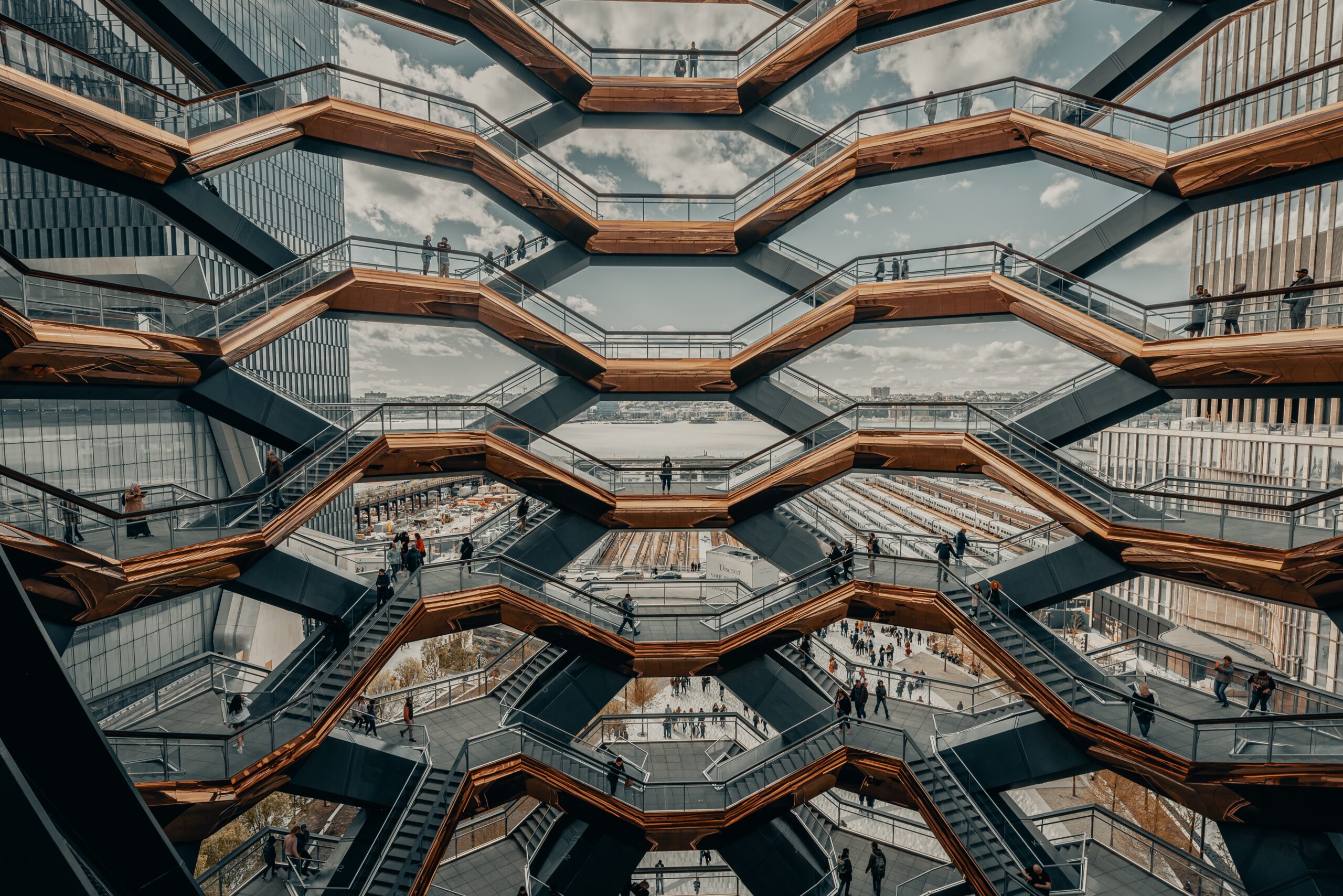 people stood in the window of a honeycomb building. 