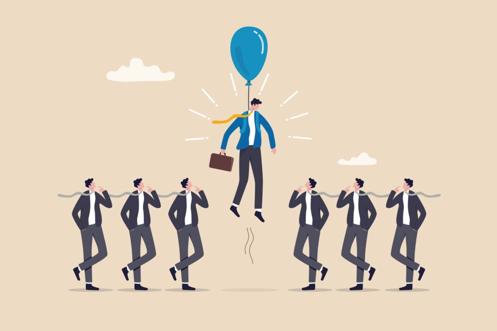 7 business men lined up with one in color being lifted up by a balloon